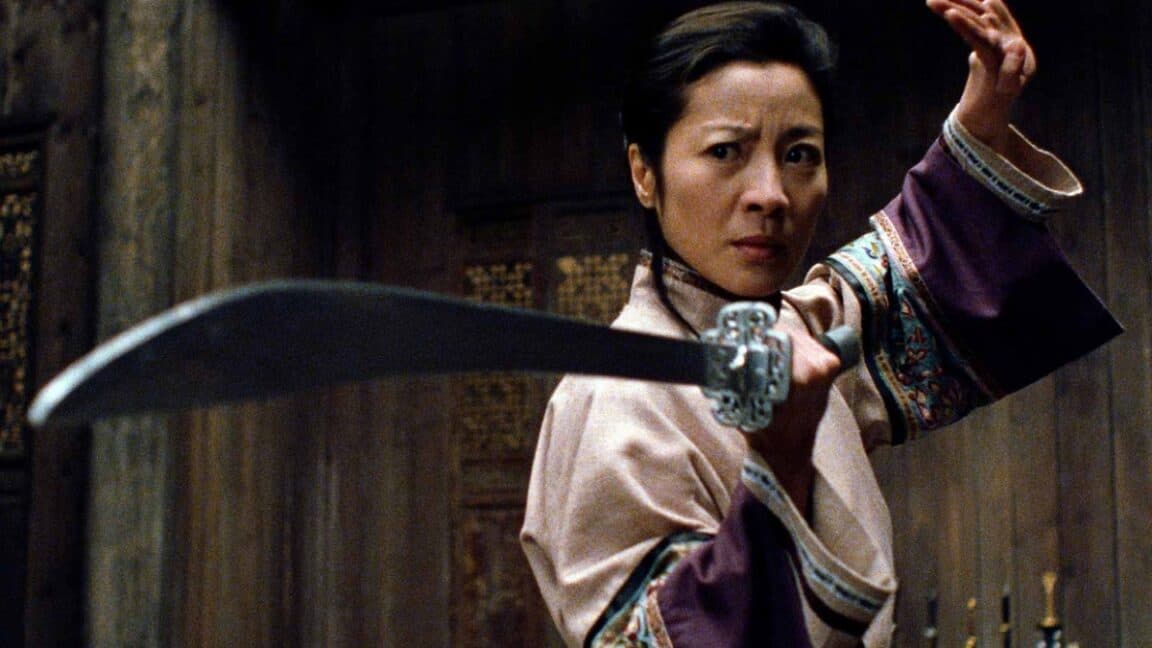 Michelle Yeoh in wuxia period garb brandishing a sword in a fighting stance