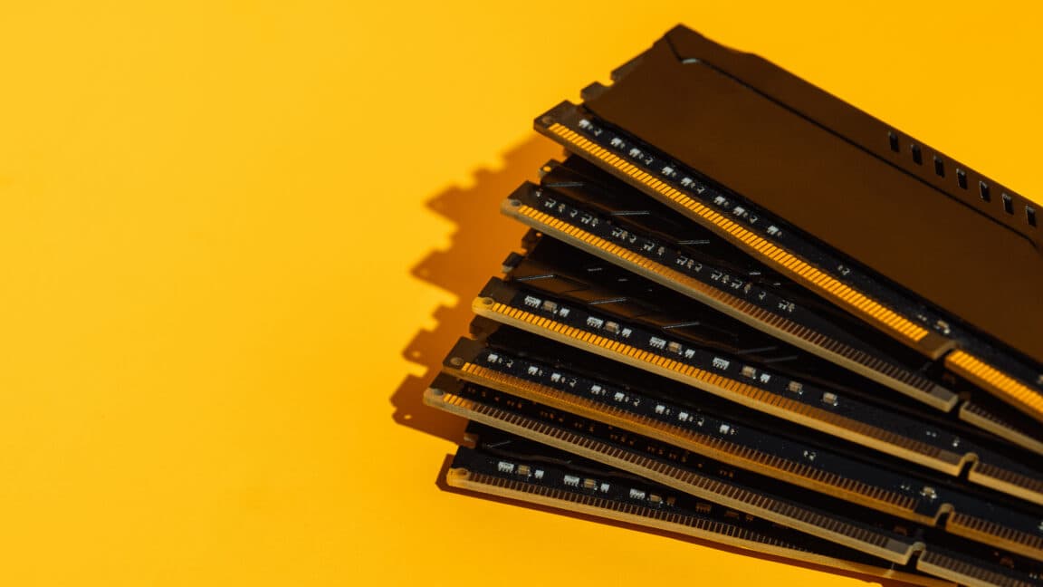 Fan arrangement of RAM sticks on yellow background.