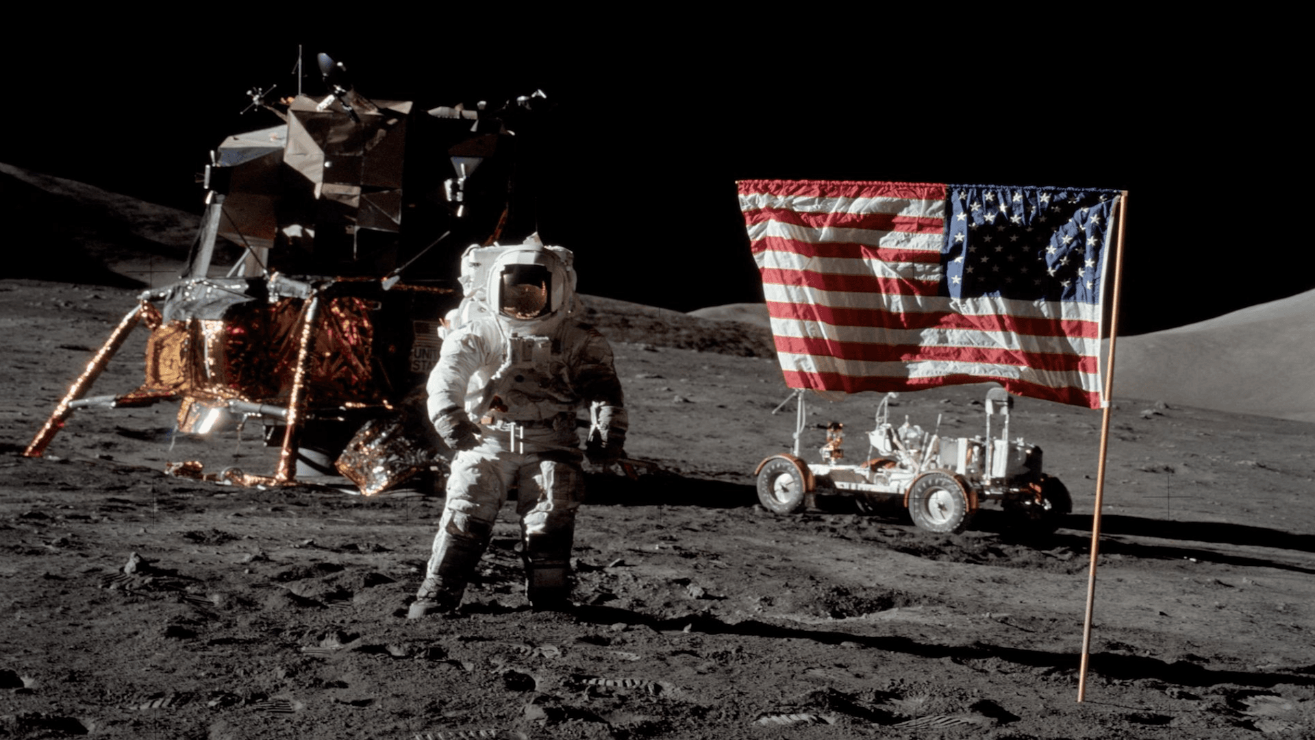 a NASA astronaut on the moon beside the American flag