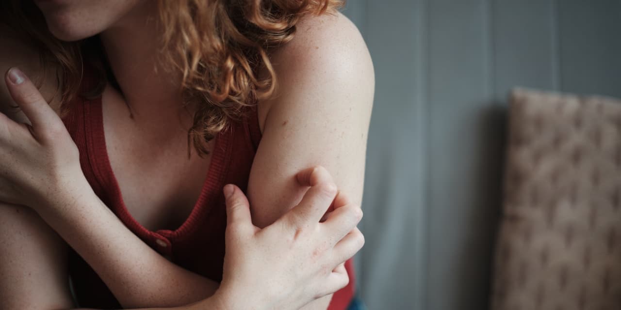 Close-up of a woman scratching her arm. (via wsj.com)
