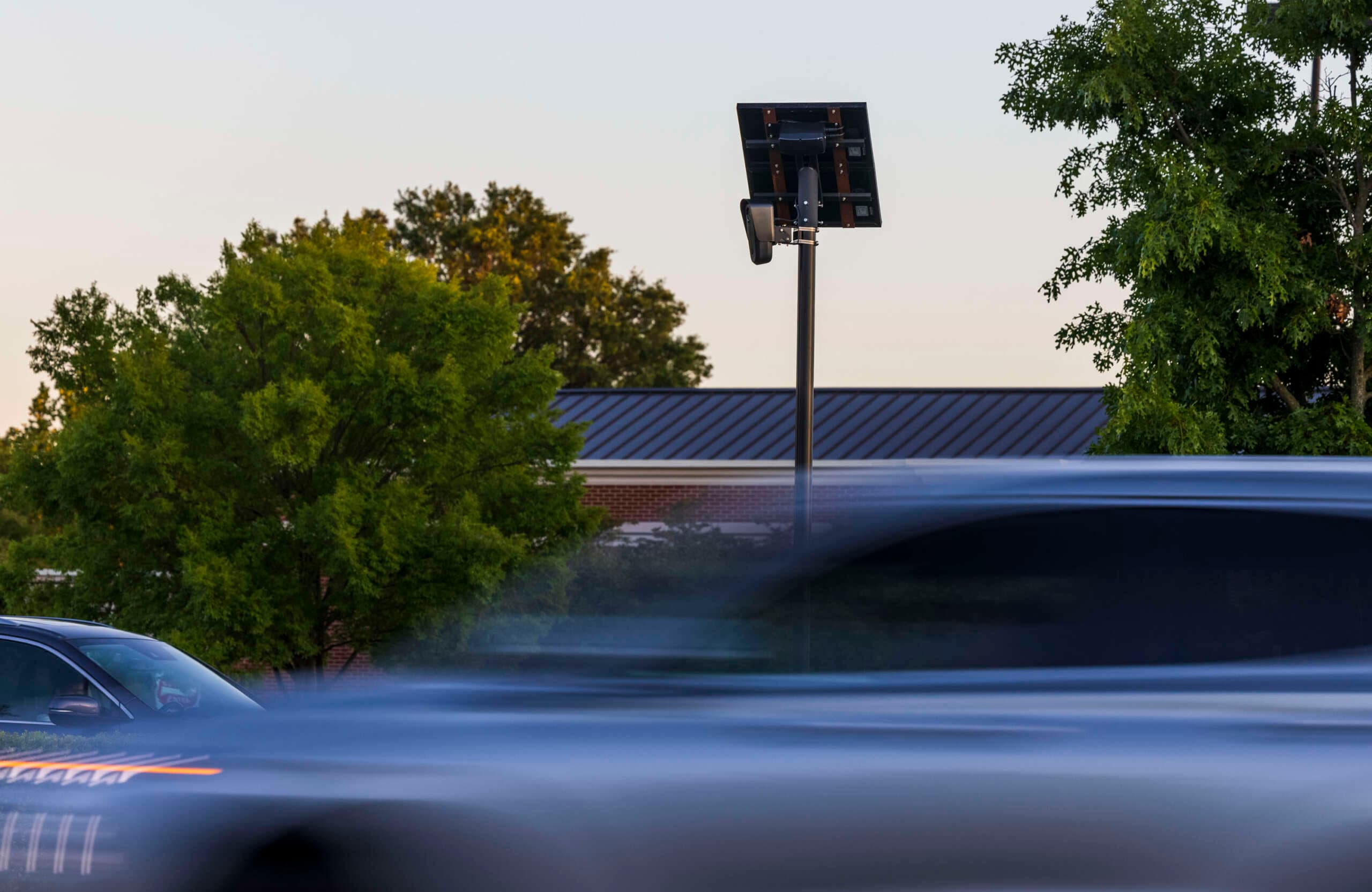 Cars drive by a Flock camera, an automated license plate reader, on East Little Creek Road in Norfolk, Virginia, on May 21, 2024. (via truthout.org)