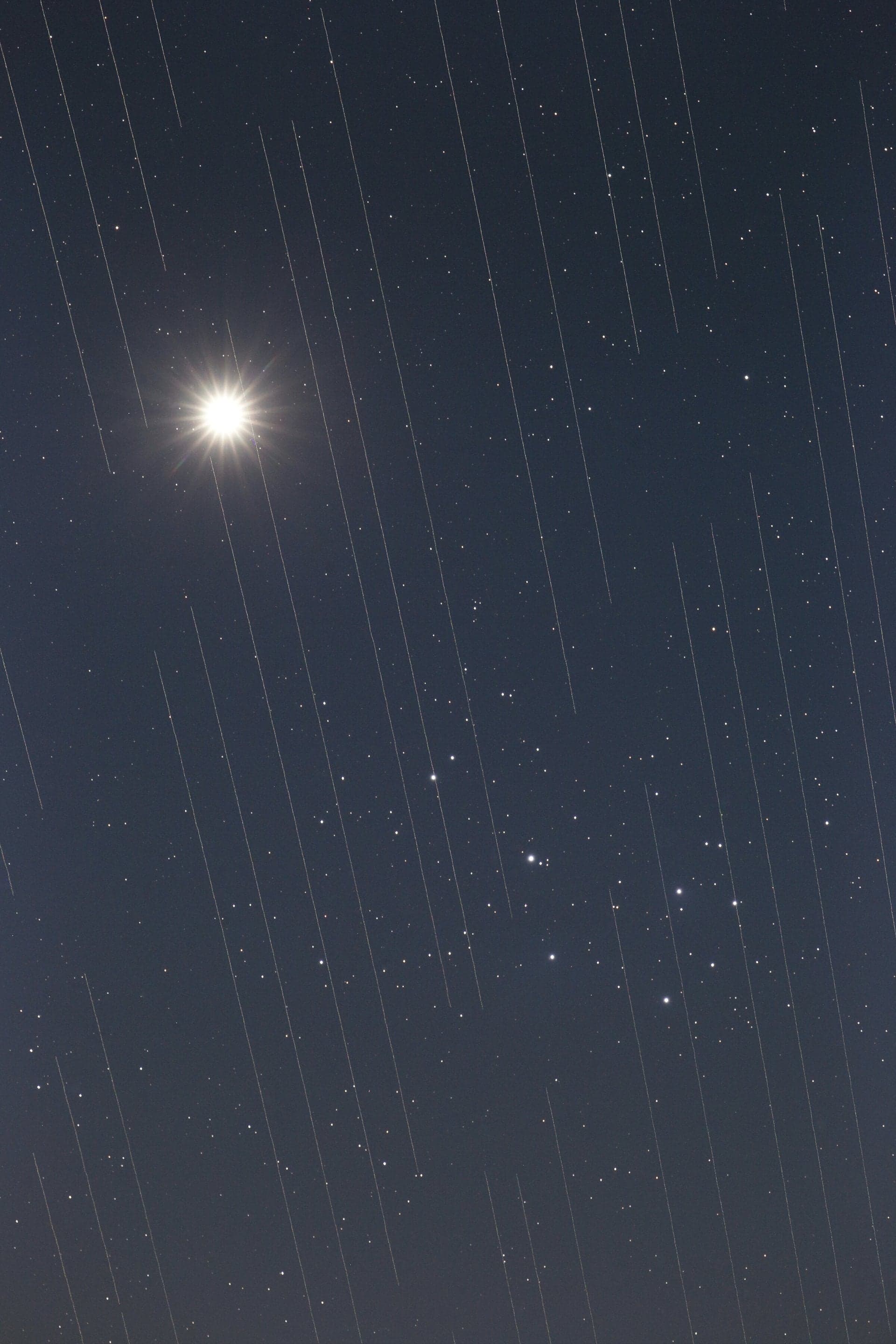 Image of Starlink satellites crossing in front of Venus and the Pleiades cluster. Credit - Torsten Hansen/IAU OAE