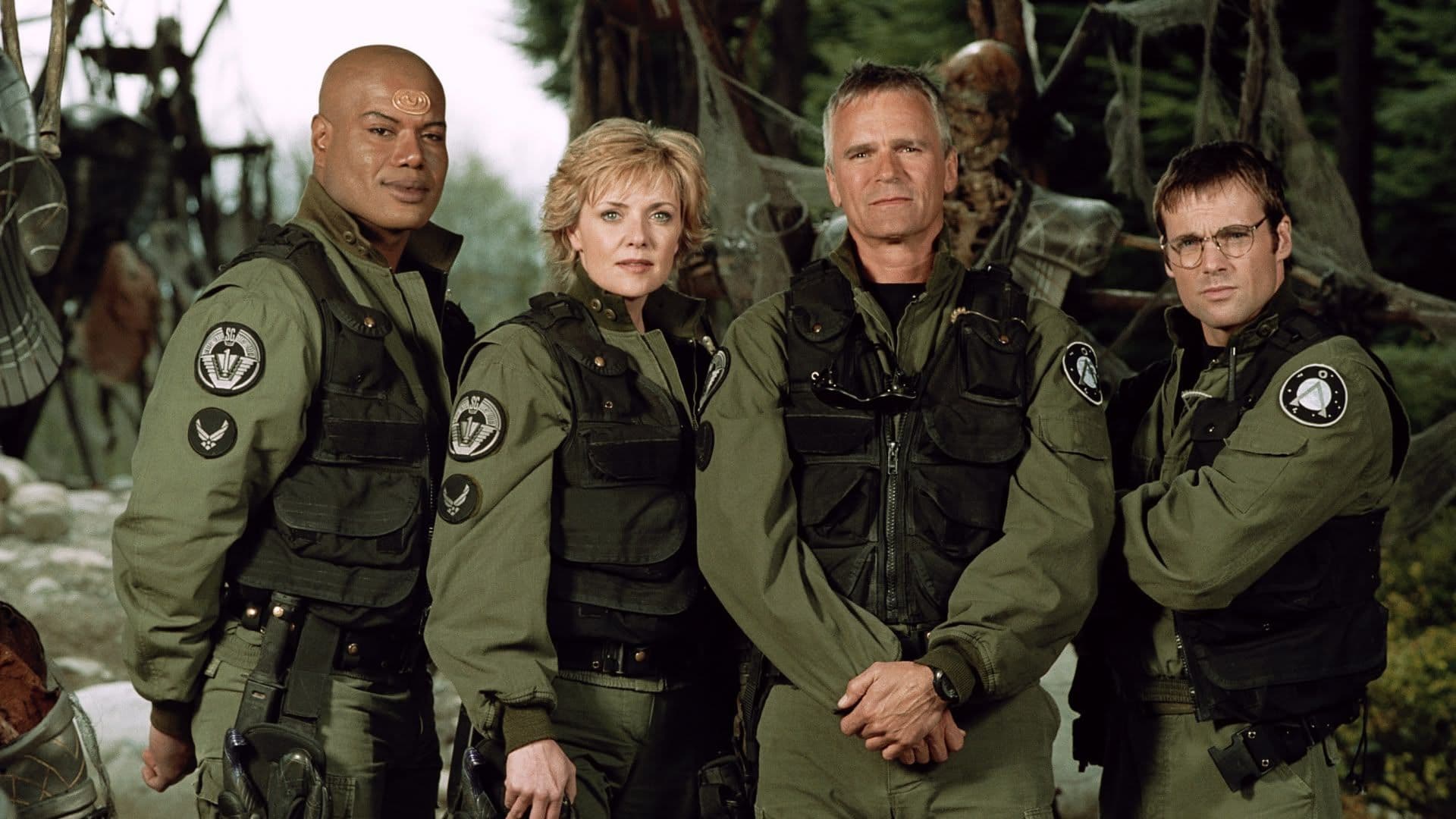 Screenshot from Stargate SG-1 showing the four main cast members in military attire.