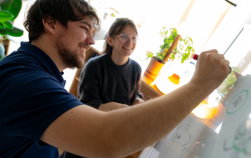 PhD student Lukas Einramhof and Assistant Professor Lisa Bugnet at a whiteboard (via ista.ac.at)