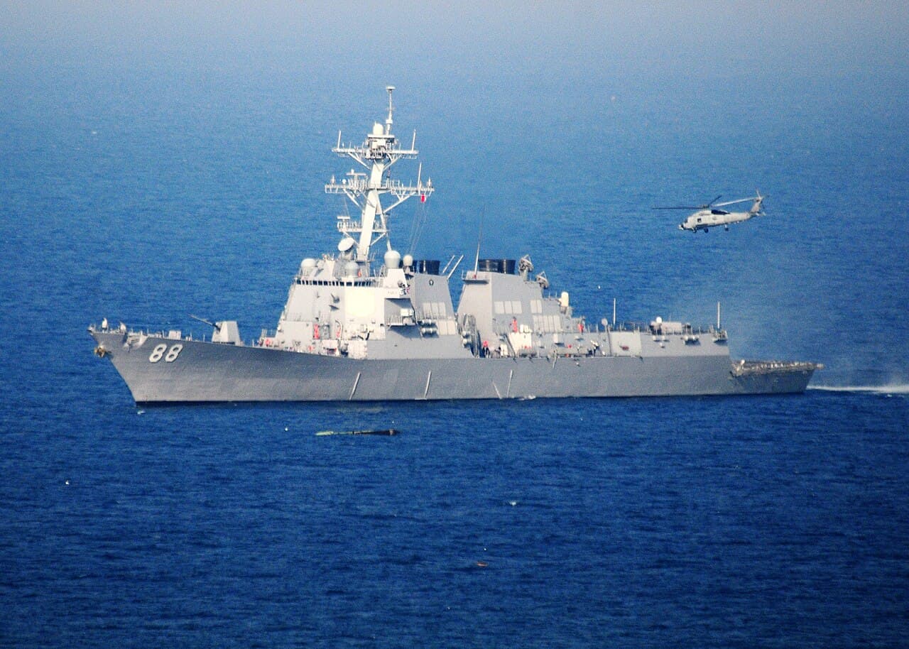 Guided-missile destroyer USS Preble DDG-88 at sea with helicopter lifting off