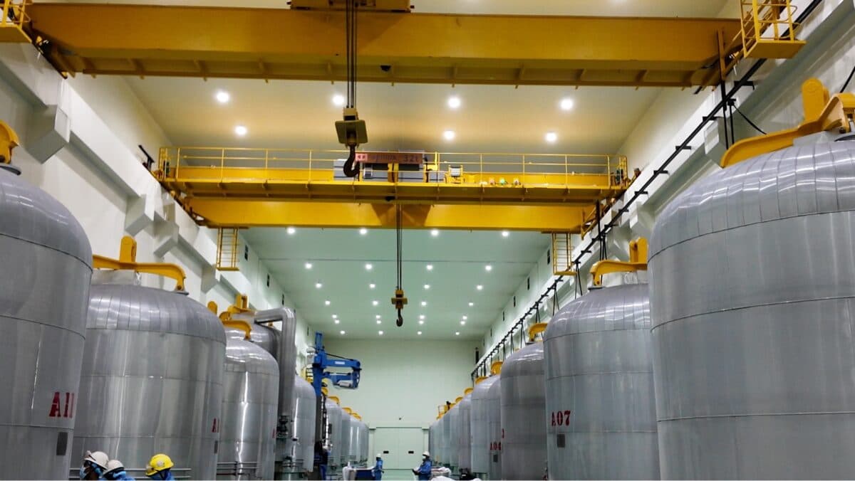 Polysilicon furnaces - large silver silos inside a factory room.