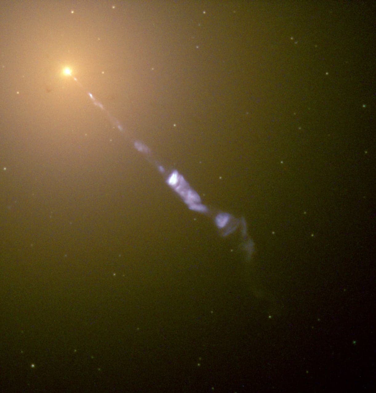 The elliptical galaxy M87 emitting a relativistic jet. When the jet points at Earth it is classed as a blazar and it is these that are thought to have generated some of the most energetic particle yet. (Credit : NASA and The Hubble Heritage Team)