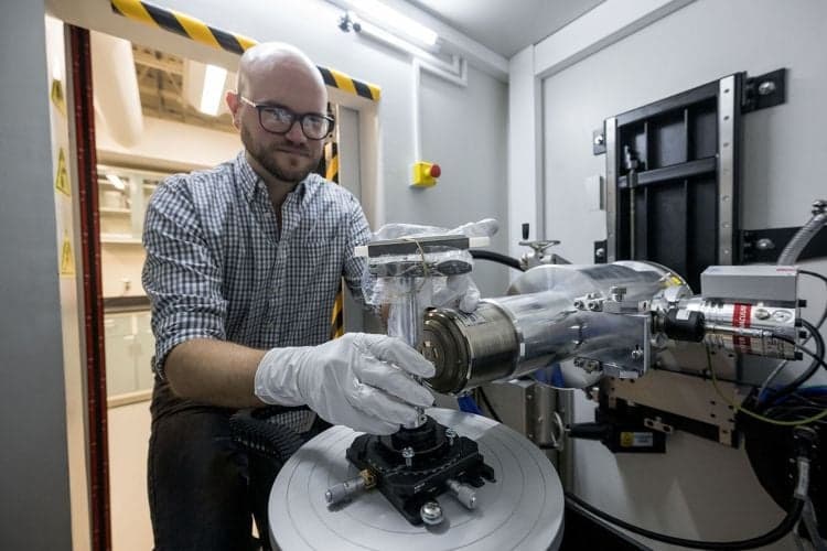 Study co-author and NASA X-ray scientist, Dr. Scott Eckley, seen loading a Bennu sample into an X-ray Computed Tomography (XCT) machine that was used for the study. (Credit: NASA/Robert Markowitz)